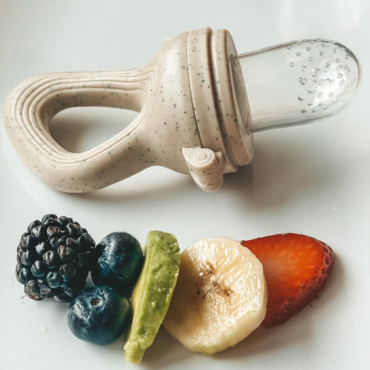Baby food teether for introducing fruit and vegetable solids; soft silicone feeder soothes teething and encourages self-feeding.
