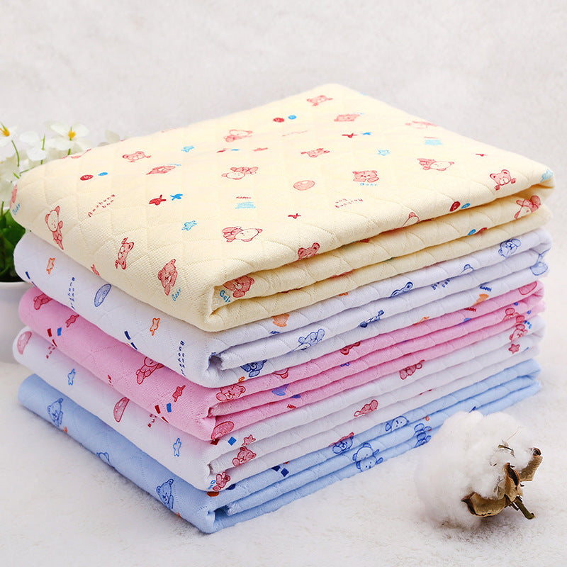 Stack of cotton hooded baby blankets in pastel colors with cartoon prints. Lightweight space cotton quilts perfect for warm seasons.