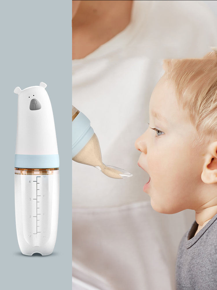 Soft silicone baby rice cereal spoon feeder with squeeze function for mess-free feeding.
