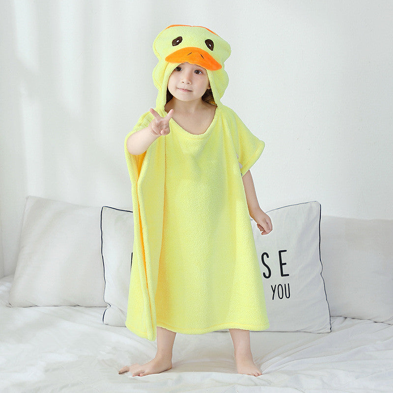 Toddler in yellow hooded towel with giraffe design. Infant bathrobe made from soft, antibacterial polyester for safe baby care.