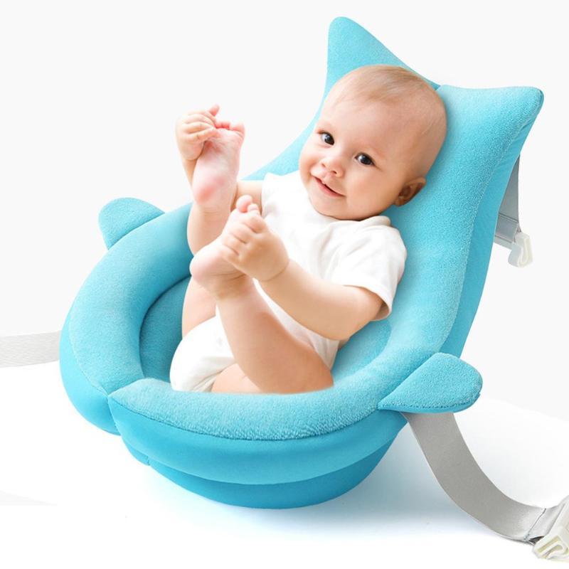 Newborn sitting comfortably in Sea Heart Blue Baby Shower Bath Net, made of soft towel fabric with secure straps for bath time safety.