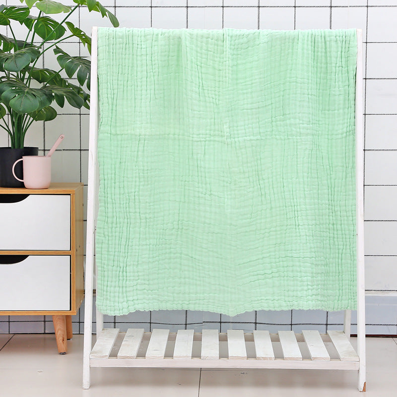 Yellow cotton baby bath towel with soft quilted seersucker layers, designed for quick drying and baby comfort.