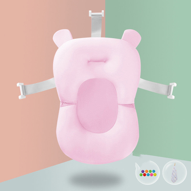 Pink baby bath sponge with lion teether accessory, designed for spine protection and secure infant bathing.