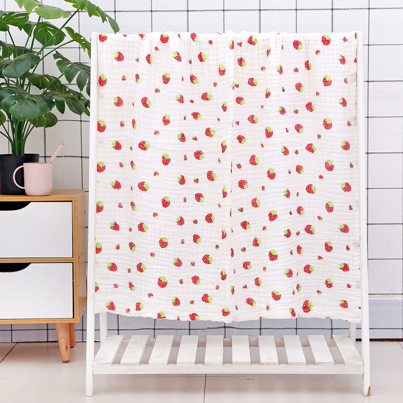 Folded citrus fruit print cotton baby bath towel with soft seersucker quilt texture, perfect for baby bath time.