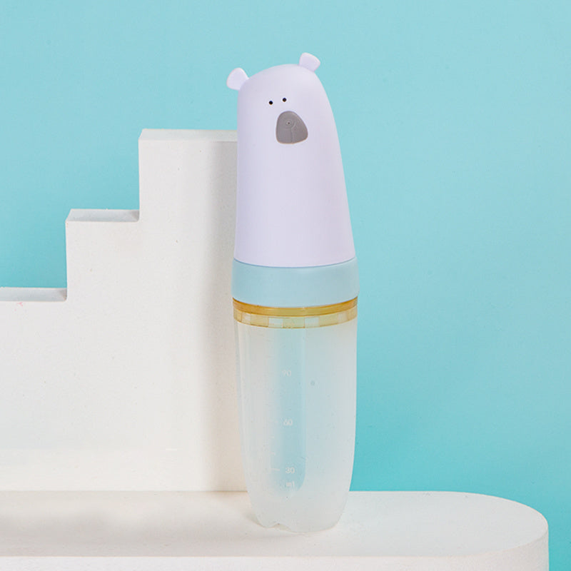 Soft silicone baby rice cereal spoon feeder with squeeze function for mess-free feeding.
