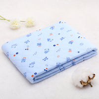 Folded light blue cotton baby blanket with cartoon bear pattern. Soft and thin quilt perfect for spring and summer.