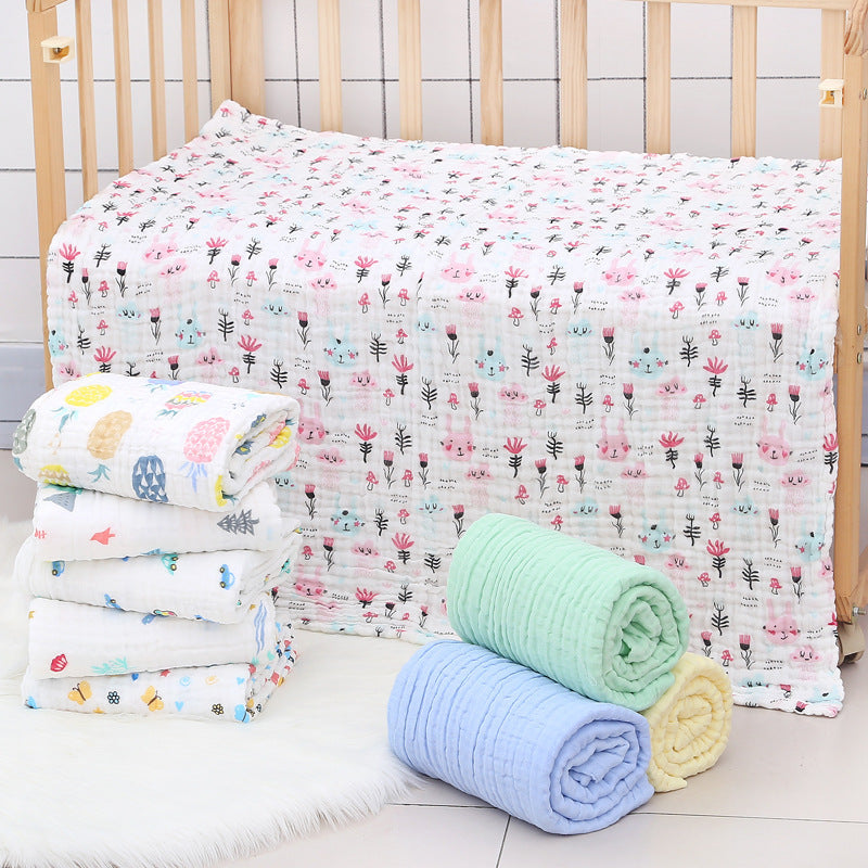 Cotton baby bath towel with six-layer seersucker quilt in assorted pastel colors and prints, ideal for quick drying and gentle baby care.