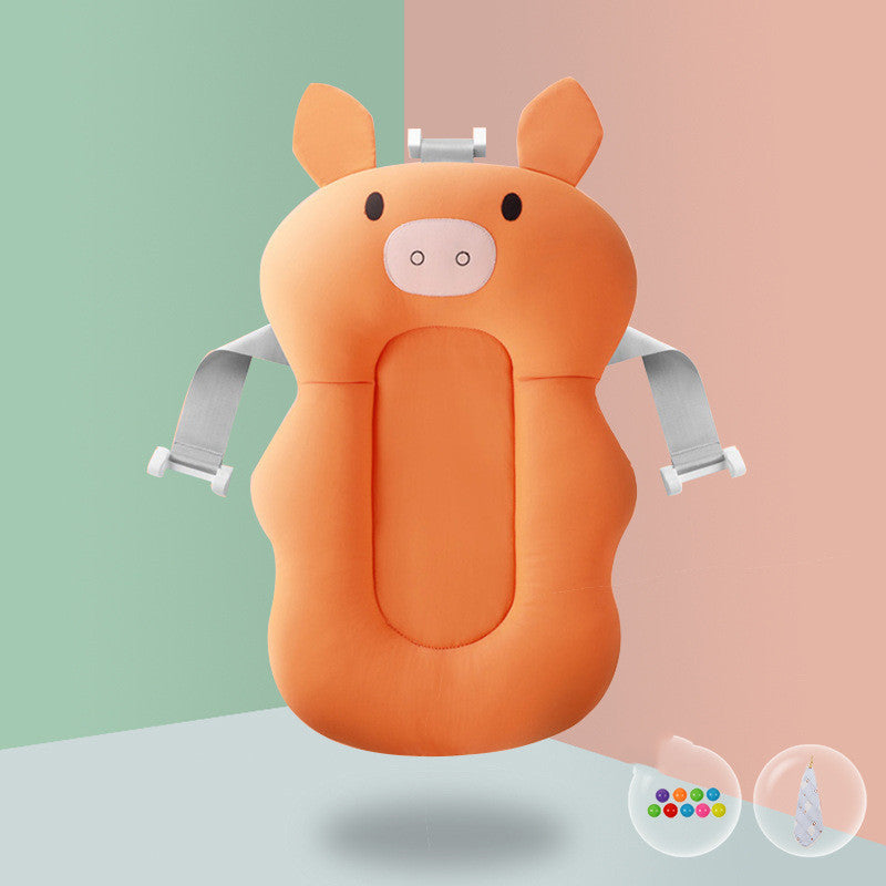 Orange pig-shaped baby bath sponge with pink lion teether, offering spine support and fun infant bathing.