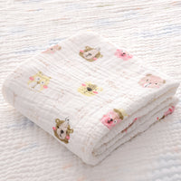 Folded yellow duck print cotton baby bath towel with soft seersucker quilt, ideal for newborns and quick moisture absorption.