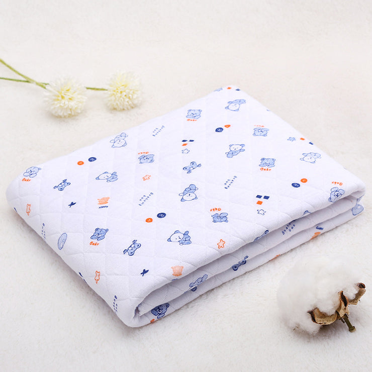 White cotton hooded baby blanket with blue cartoon bear print. Soft quilted fabric perfect for spring and summer use.