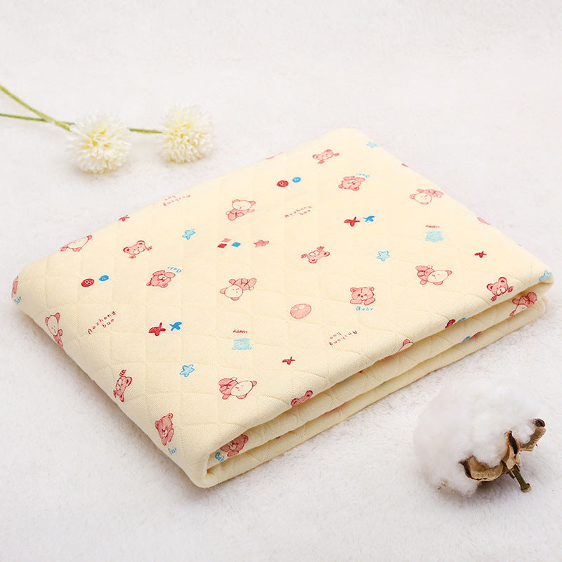 Folded yellow cotton baby blanket with cartoon print, made from breathable space cotton. Ideal for warm weather use.
