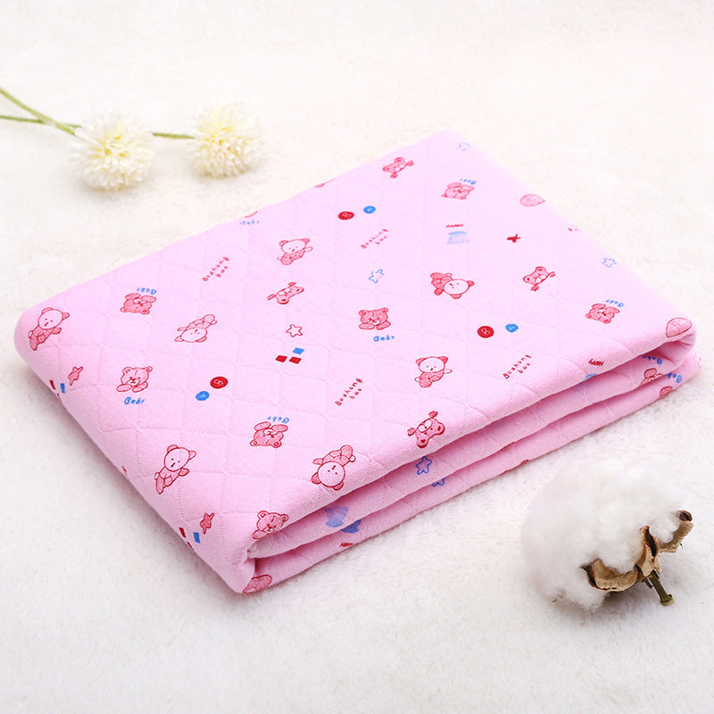 Folded pink cotton baby blanket with cartoon print. Lightweight and breathable quilt for summer and spring comfort.
