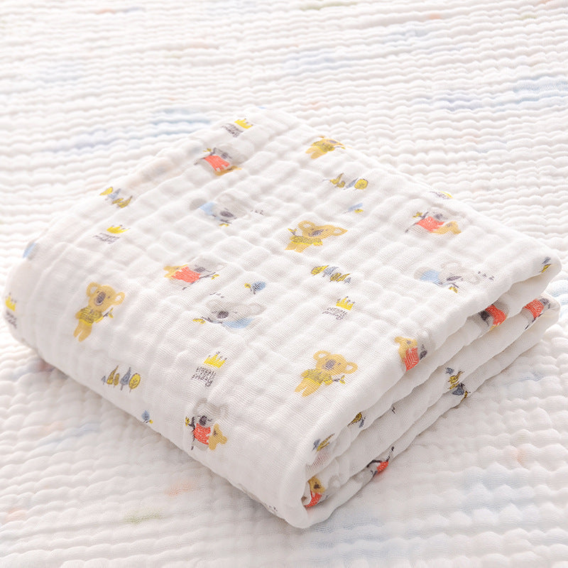 Folded cotton baby bath towel with yellow koala print, featuring soft six-layer seersucker quilt for newborn comfort.