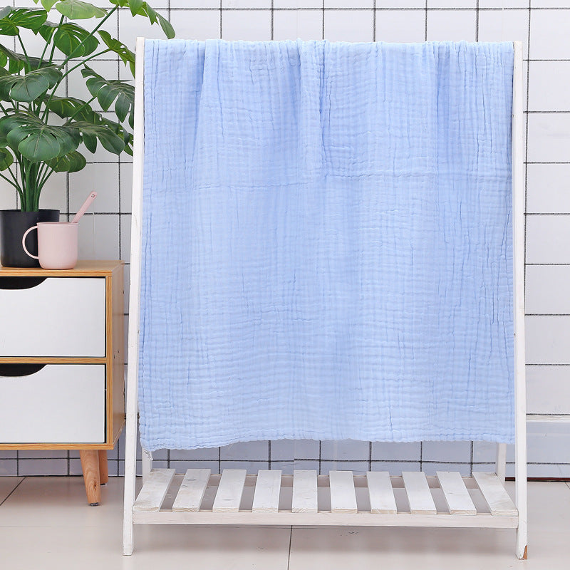 Colorful dinosaur print baby bath towel made of soft cotton seersucker quilt, ideal for toddlers and quick moisture absorption.