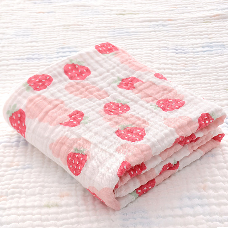 Folded cotton baby bath towel with yellow and gray animal print, featuring soft six-layer seersucker quilt for baby comfort.