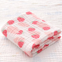 Folded cotton baby bath towel with yellow and gray animal print, featuring soft six-layer seersucker quilt for baby comfort.