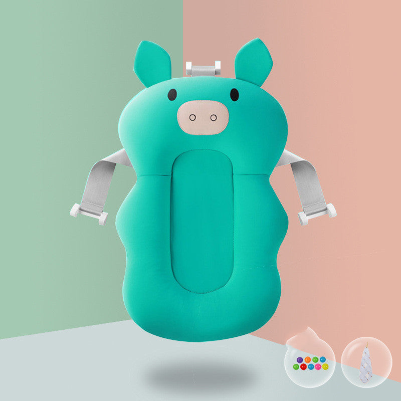 Green pig-shaped baby bath sponge with pink lion teether, ensuring spine protection and playful bathing.