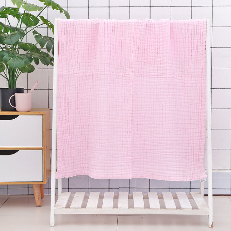 Green cotton baby bath towel with six-layer seersucker quilt texture, breathable and gentle for infant use.