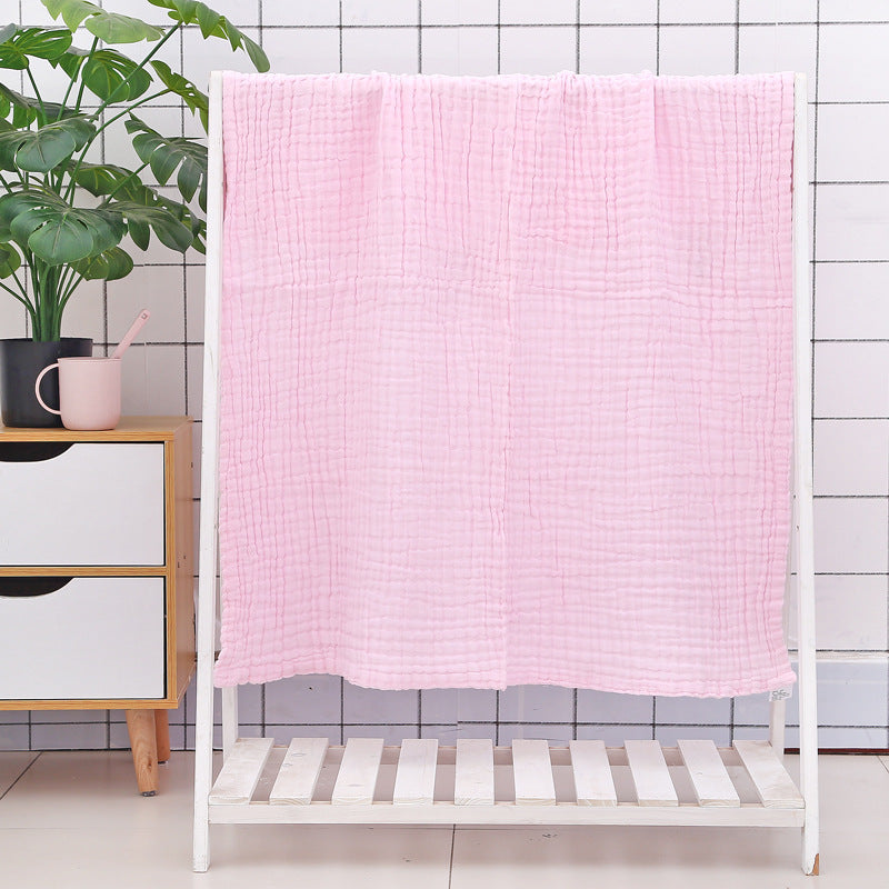Green cotton baby bath towel with six-layer seersucker quilt texture, breathable and gentle for infant use.
