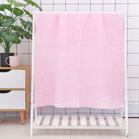 Green cotton baby bath towel with six-layer seersucker quilt texture, breathable and gentle for infant use.