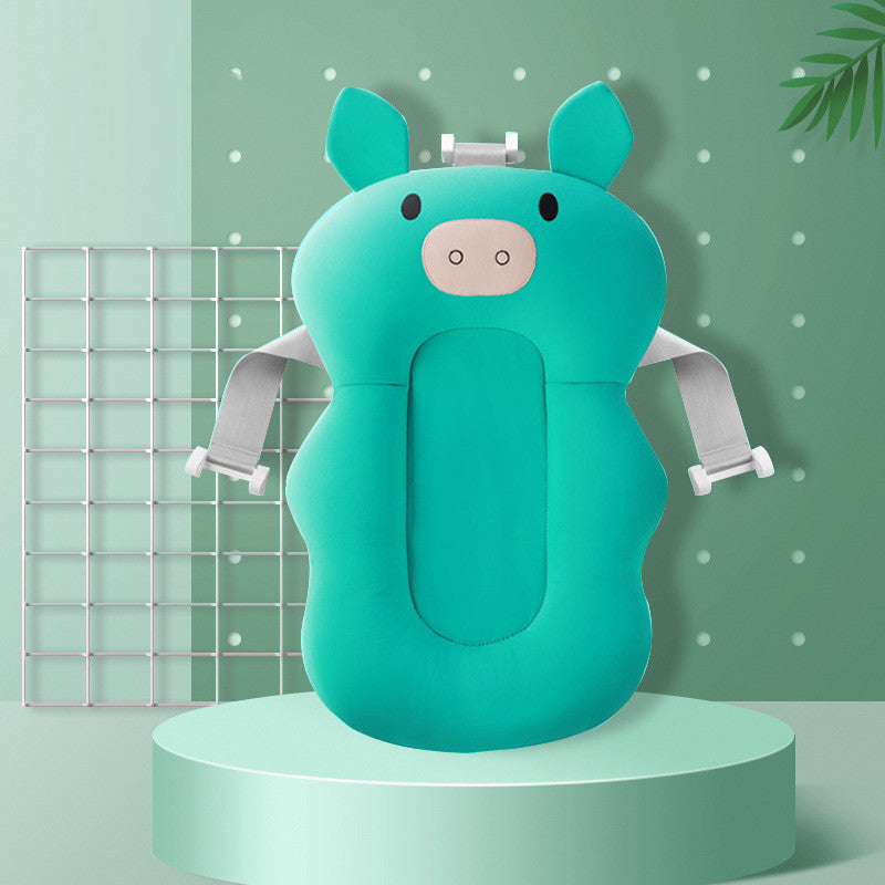 Green pig baby bath sponge with colorful bath beads and feather toy, offering safe and fun bath time.